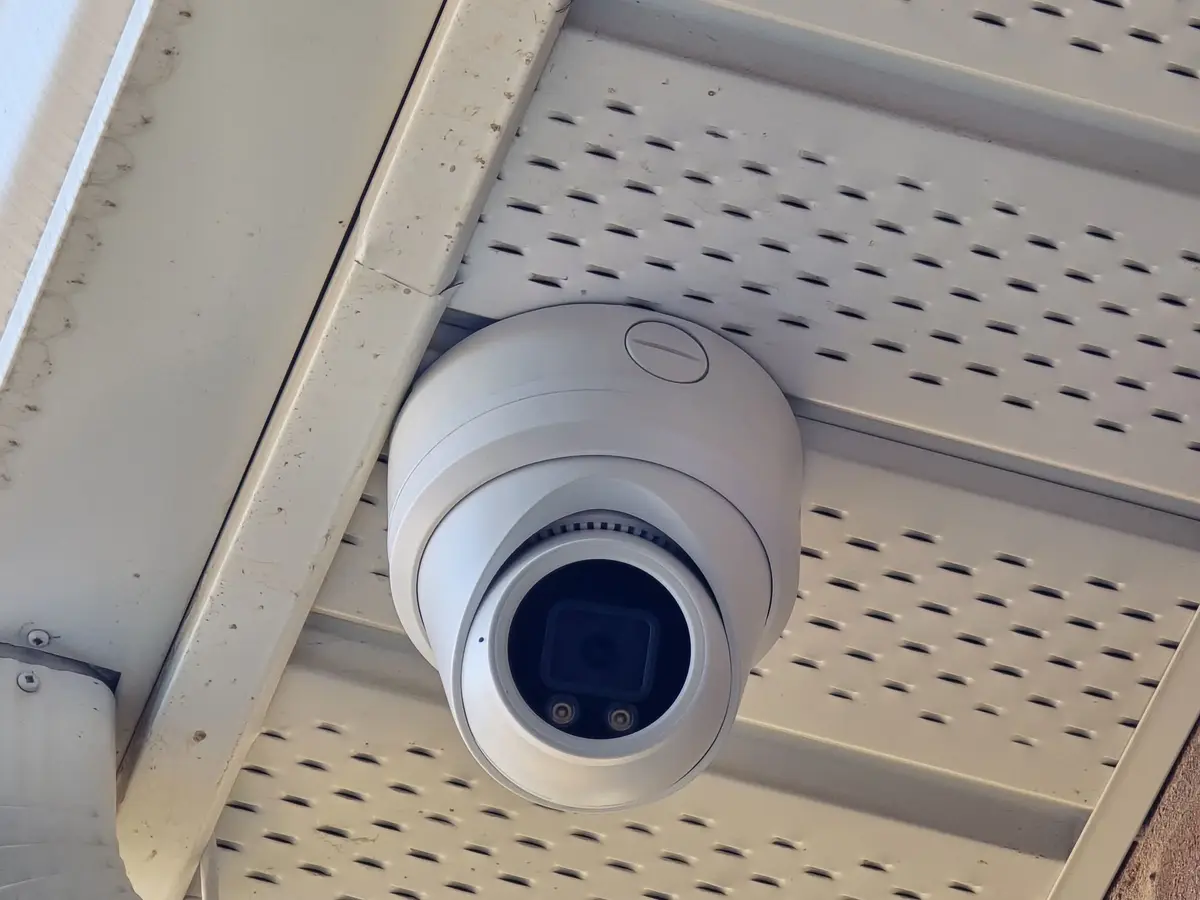 Close-up of a white turret camera in a vented soffit