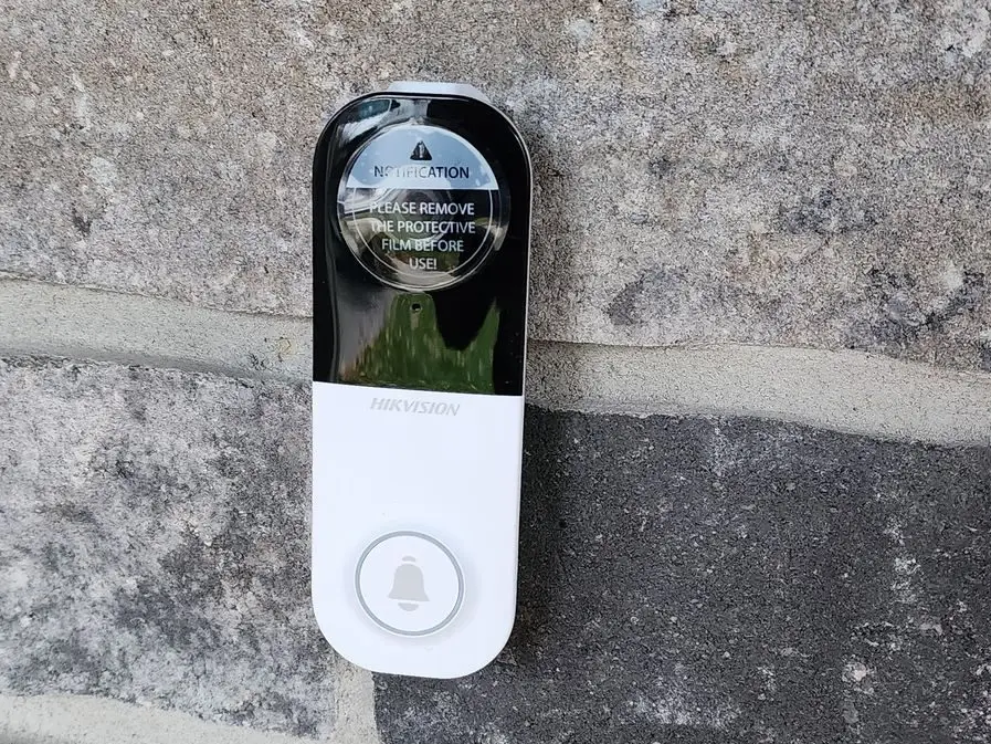Video doorbell installed on a stone front wall